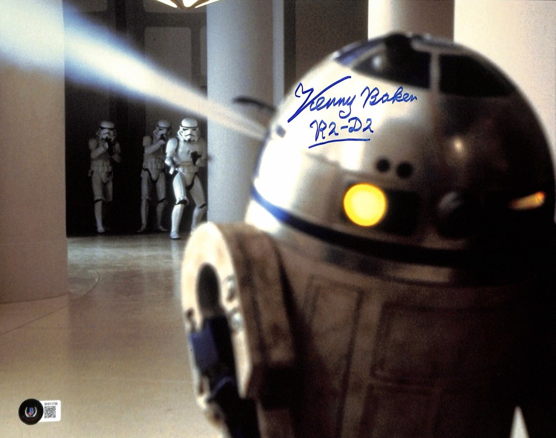 Beckett Certified 11x14 Star Wars ESB Photo Signed by Kenny Baker as R2-D2: Beckett Certified 11x14 Star Wars ESB Photo Signed by Kenny Baker as R2-D2 Autographed 11x14 photograph signed in blue permanent marker by Kenny Baker as R2-D2 from Star Wars The Empire Strikes Back. 