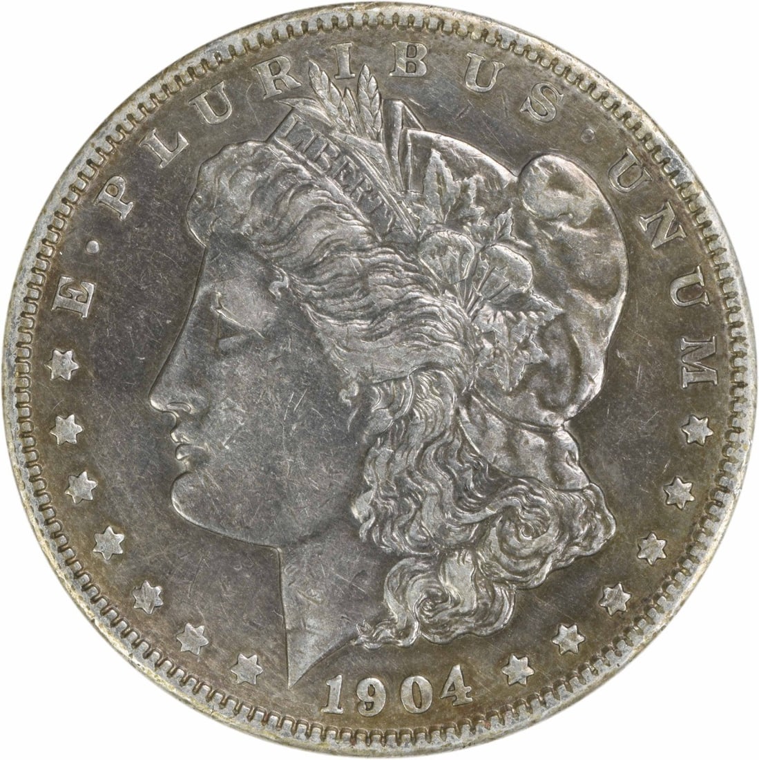 1904 Morgan Silver Dollar EF Uncertified 90% Silver Coin: 1904 Morgan Silver Dollar EF Uncertified 90% Silver Coin This 1904 Morgan Silver Dollar is an exquisite piece from the Philadelphia Mint, featuring a classic design by George T. Morgan. The coin is co
