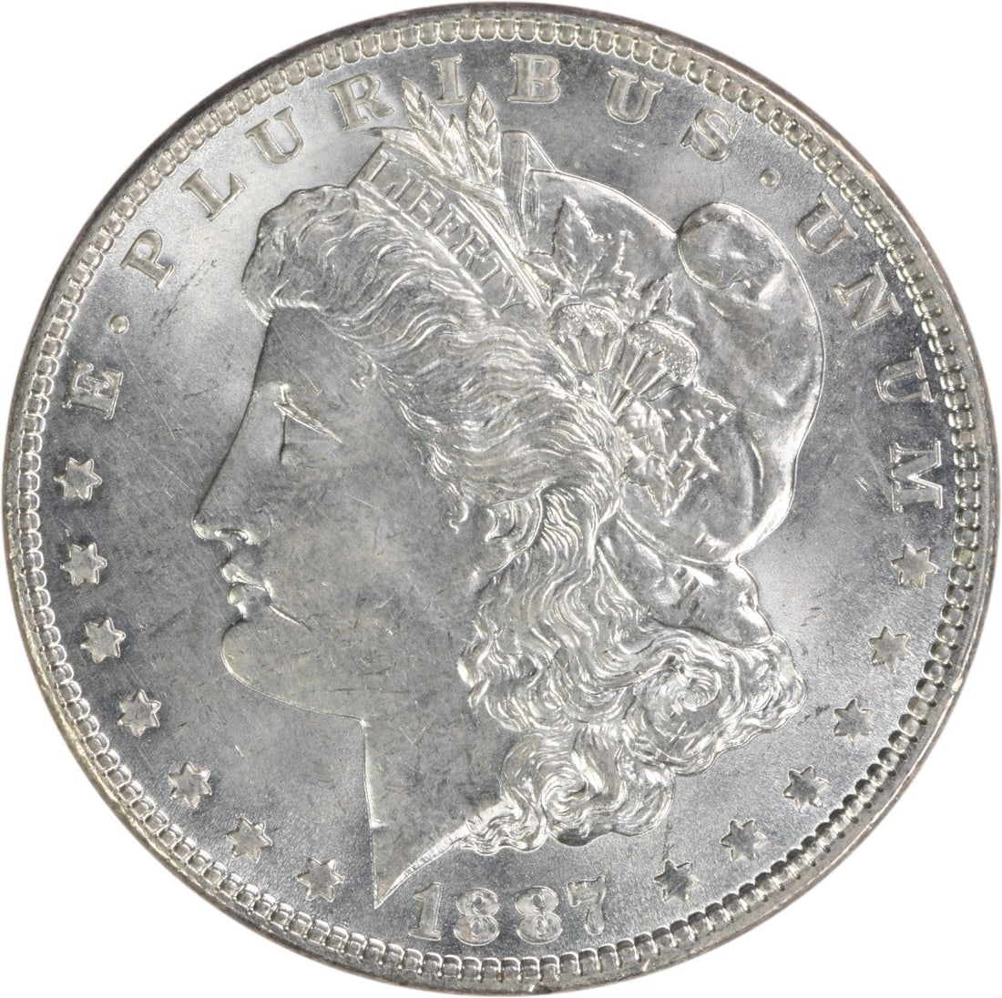 Brilliant Uncirculated 1887 Silver Morgan Dollar Uncertified No Mint Mark: Brilliant Uncirculated 1887 Silver Morgan Dollar Uncertified No Mint Mark This is an 1887 Morgan Silver Dollar from the United States, featuring a brilliant uncirculated (BU) grade. The coin is made o