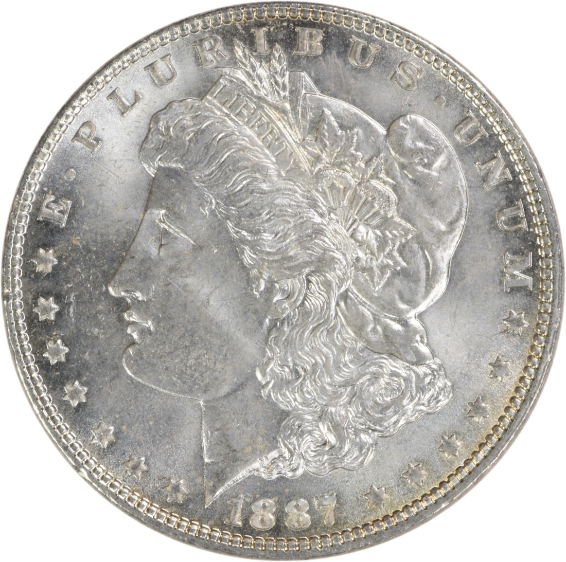 Choice BU 1887 Silver Morgan Dollar Uncertified US Coin: Choice BU 1887 Silver Morgan Dollar Uncertified US Coin This 1887 Morgan Silver Dollar is an uncirculated coin graded as Choice BU. Struck without a mint mark, it is composed of silver and features th