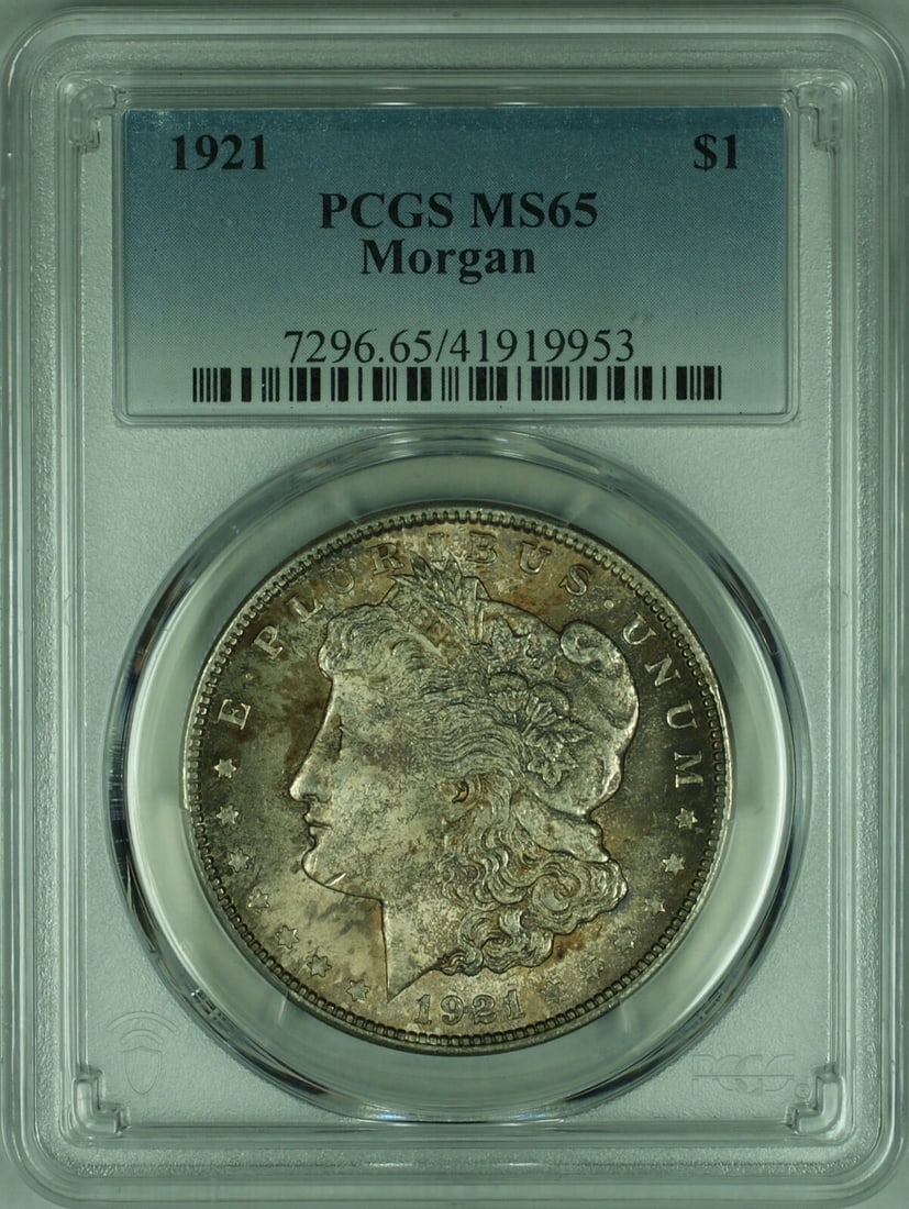 PCGS MS65 1921 Morgan Silver Dollar: PCGS MS65 1921 Morgan Silver Dollar This is a 1921 Morgan Silver Dollar graded MS-65 by PCGS. The coin is uncirculated, features attractive toning, and was minted in Philadelphia. It is composed of 90
