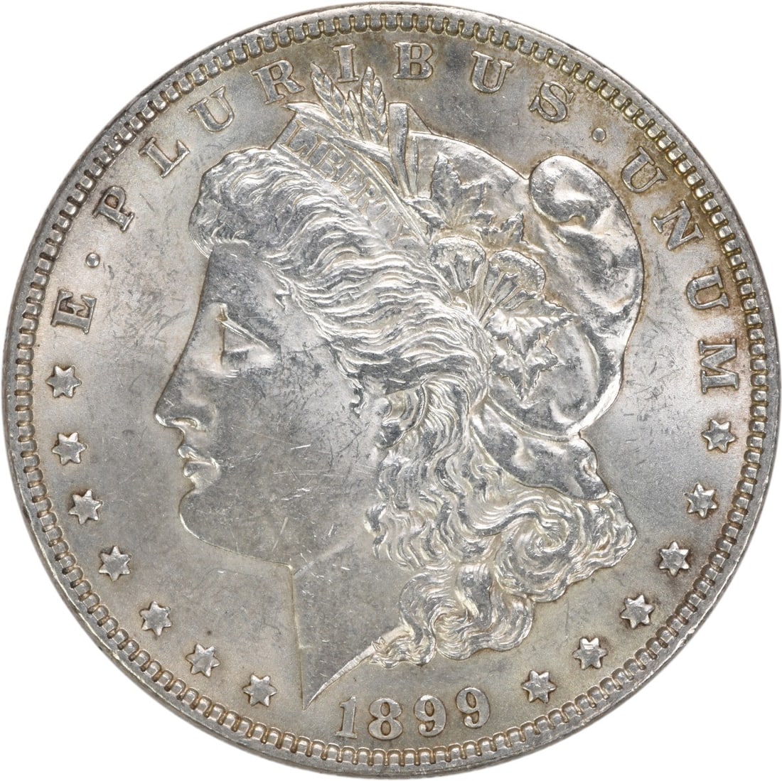 1899 Morgan Silver Dollar AU Uncertified Philadelphia Coin: 1899 Morgan Silver Dollar AU Uncertified Philadelphia Coin This 1899 Morgan Silver Dollar is a beautiful representation of American coinage, featuring a design by George T. Morgan. The coin is circula