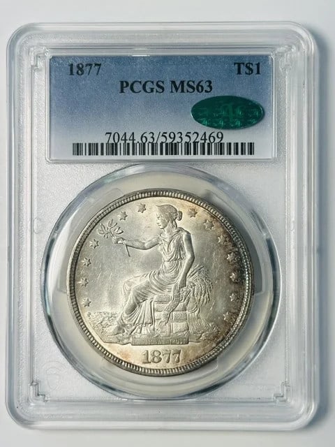 1877 Philadelphia Silver Trade Dollar PCGS MS63 CAC: 1877 Philadelphia Silver Trade Dollar PCGS MS63 CAC 1877 Trade Dollar certified by PCGS as MS-63 and approved by CAC. This pre-owned silver dollar was minted in Philadelphia and issued in the United S