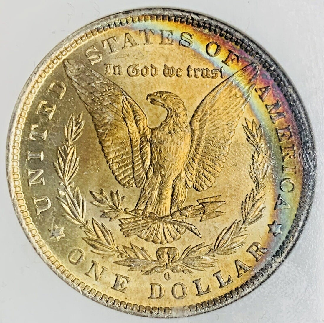 NGC MS 63 1884-O Morgan Dollar Silver Coin With Rainbow Toning: NGC MS 63 1884-O Morgan Dollar Silver Coin With Rainbow Toning This is an 1884-O Morgan Silver Dollar featuring a rainbow tone, certified by NGC with a grade of MS 63. The coin is composed of silver, 