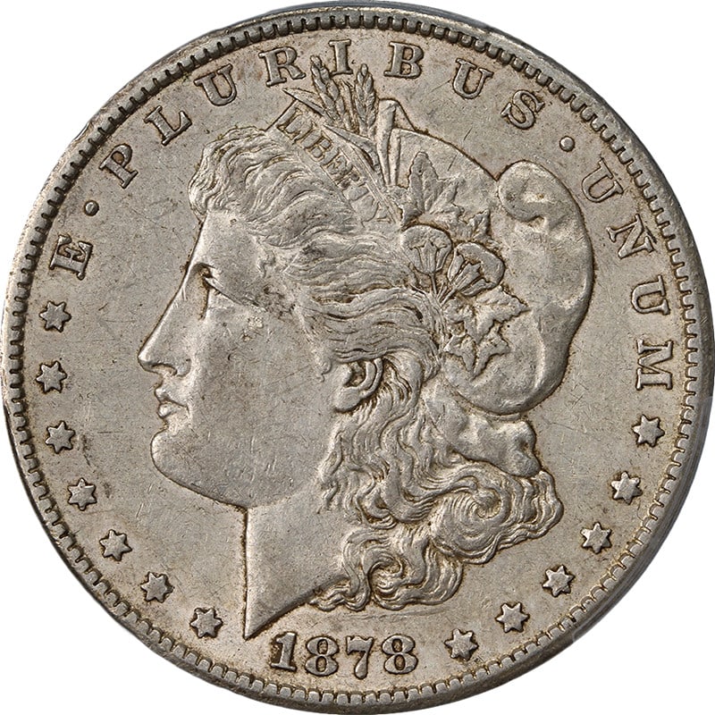PCGS AU50 1878 CC Morgan Silver Dollar: PCGS AU50 1878 CC Morgan Silver Dollar This 1878-CC Morgan Silver Dollar is a circulated coin graded PCGS AU50. It is described as having great eye appeal, a strong strike, superb color, and superb su