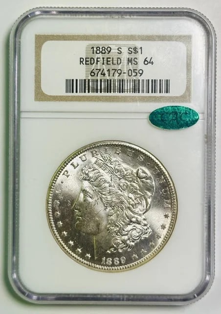 1889-S Morgan Dollar NGC MS-64 CAC Redfield Hoard: 1889-S Morgan Dollar NGC MS-64 CAC Redfield Hoard This 1889 Morgan Silver Dollar is graded MS-64 by NGC and is CAC certified. Originating from the Redfield Hoard, this coin was minted in San Francisco