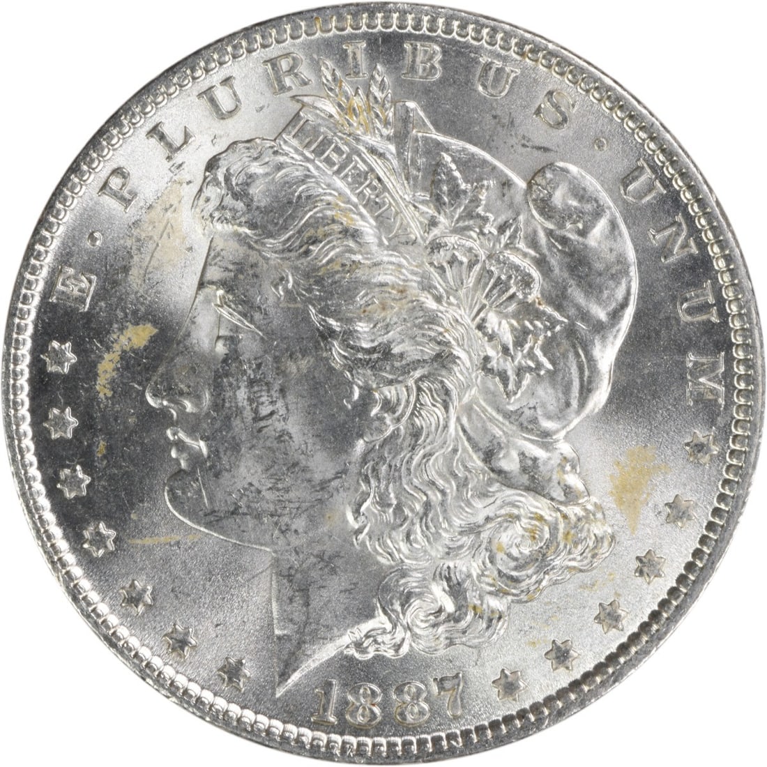 Choice BU 1887 Morgan Dollar Silver Uncirculated Coin Uncertified: Choice BU 1887 Morgan Dollar Silver Uncirculated Coin Uncertified This is an uncirculated 1887 Morgan Silver Dollar graded as Choice Brilliant Uncirculated (BU). The coin is composed of silver, has no