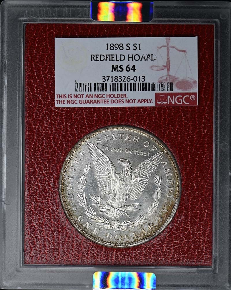 NGC MS64 1898 Morgan Silver Dollar Redfield Hoard: NGC MS64 1898 Morgan Silver Dollar Redfield Hoard 1898 Morgan Silver Dollar from the Redfield Hoard, graded MS64 by NGC. This pre-owned coin is listed as uncirculated and certified by NGC. Specificati