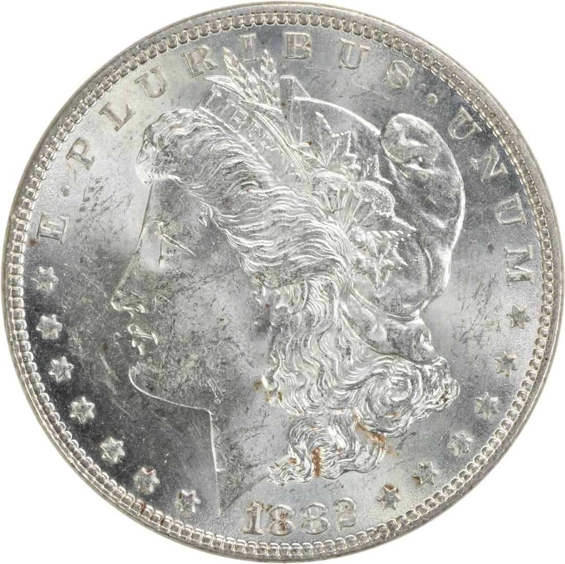 1882 Silver Morgan Dollar Brilliant Uncirculated Uncertified US Coin: 1882 Silver Morgan Dollar Brilliant Uncirculated Uncertified US Coin This is an 1882 Morgan Silver Dollar from the United States, featuring a brilliant uncirculated (BU) condition. The coin is compose