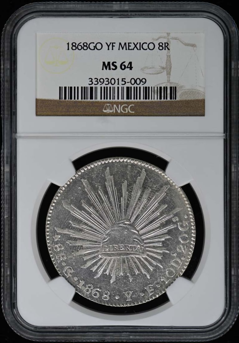 1868 Mexico 8 Reales NGC MS64 Uncirculated Coin: 1868 Mexico 8 Reales NGC MS64 Uncirculated Coin This uncirculated 1868 Mexico 8 Reales coin is graded MS64 by NGC, ensuring its excellent condition and high quality. A remarkable piece for collectors,
