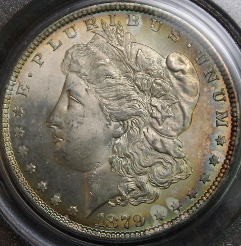PCGS MS-64 1879-S Morgan Silver Dollar with Rainbow Toning: PCGS MS-64 1879-S Morgan Silver Dollar with Rainbow Toning This is an 1879-S Morgan Silver Dollar coin graded MS-64 by PCGS. The coin features attractive rainbow toning along the edge of the obverse. 