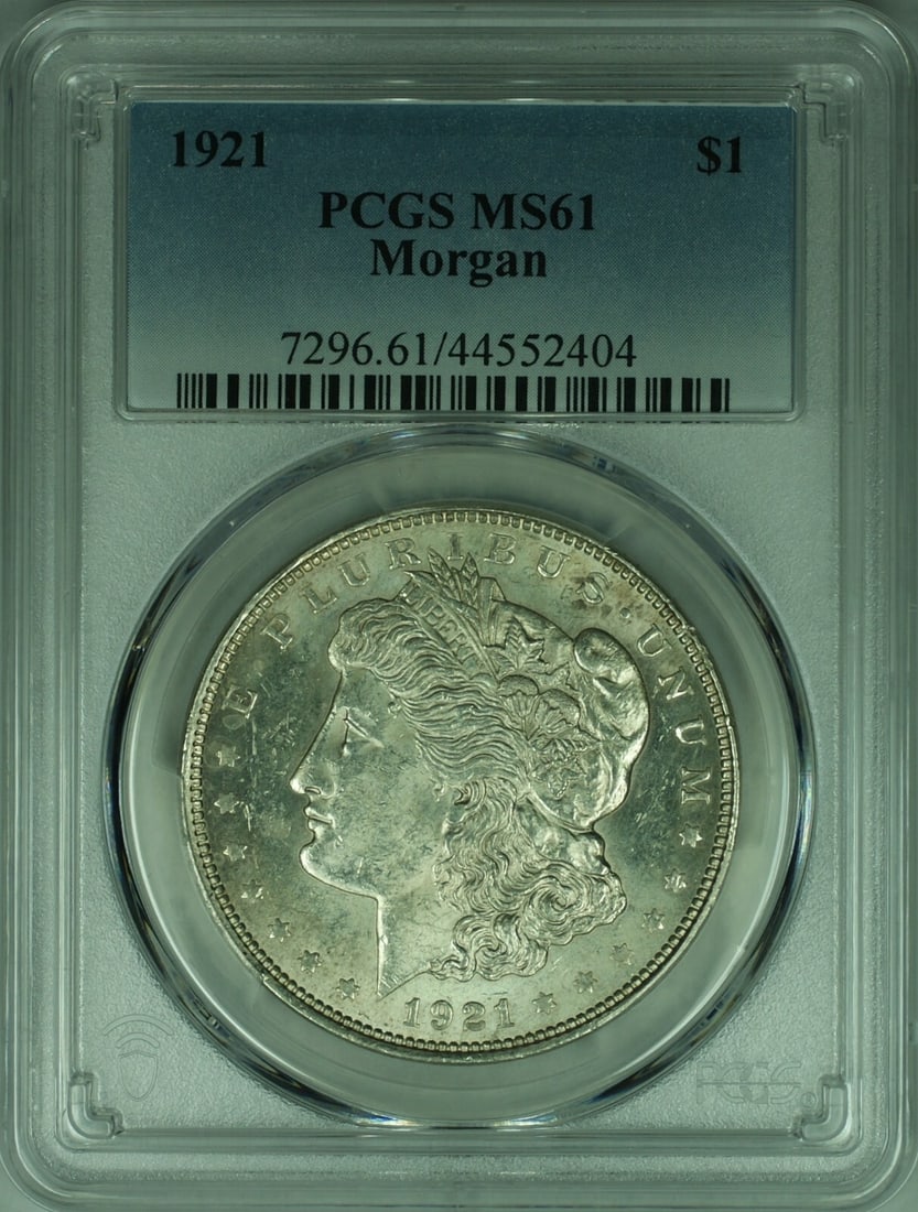 1921 Morgan Dollar Silver Coin Graded MS-61 by PCGS: 1921 Morgan Dollar Silver Coin Graded MS-61 by PCGS This is a 1921 Morgan Silver Dollar coin from the United States, graded MS-61 by PCGS. Minted in Philadelphia, the coin is uncirculated and composed