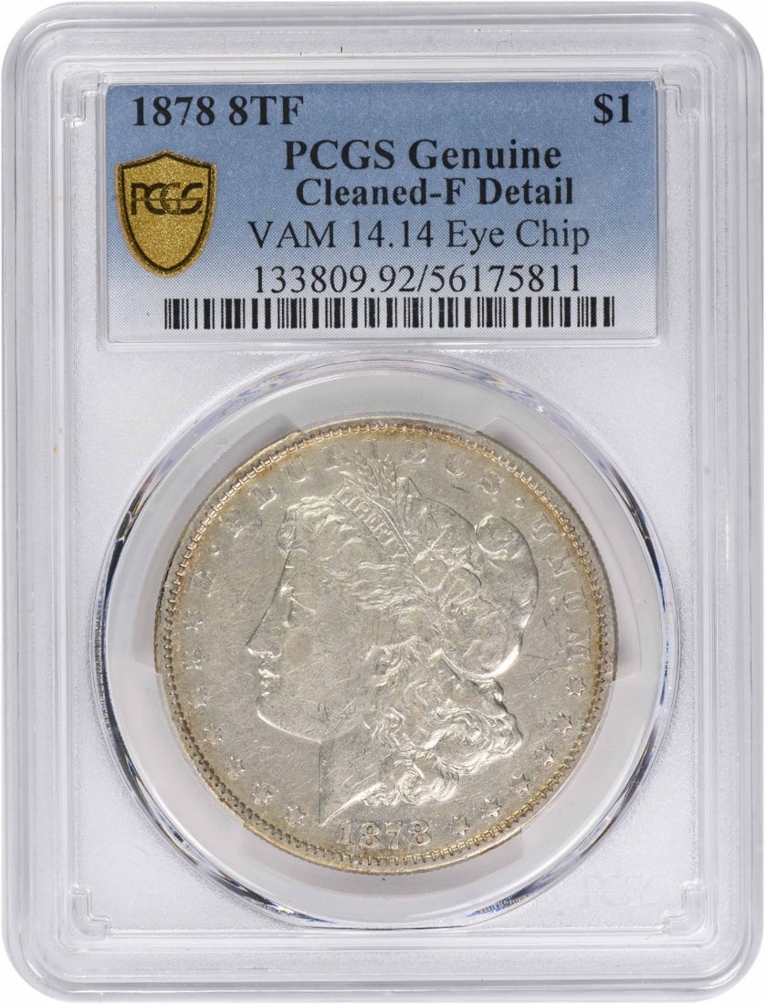 Morgan Dollar 1878 Eye Chip VAM 14.14 PCGS Genuine Cleaned F Detail: Morgan Dollar 1878 Eye Chip VAM 14.14 PCGS Genuine Cleaned F Detail This is a 1878 Morgan Dollar, 8 Tail Feathers VAM 14.14 variety, featuring an eye chip. The coin is certified genuine by PCGS, with 
