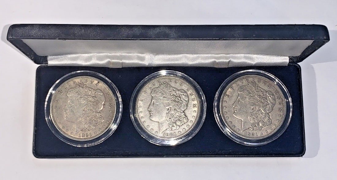 Three-Piece 1921 Morgan Silver Dollar Set in Littleton Display Case: Three-Piece 1921 Morgan Silver Dollar Set in Littleton Display Case This set features three 1921 Morgan Silver Dollars from the Philadelphia (P), Denver (D), and San Francisco (S) mints, presented in 