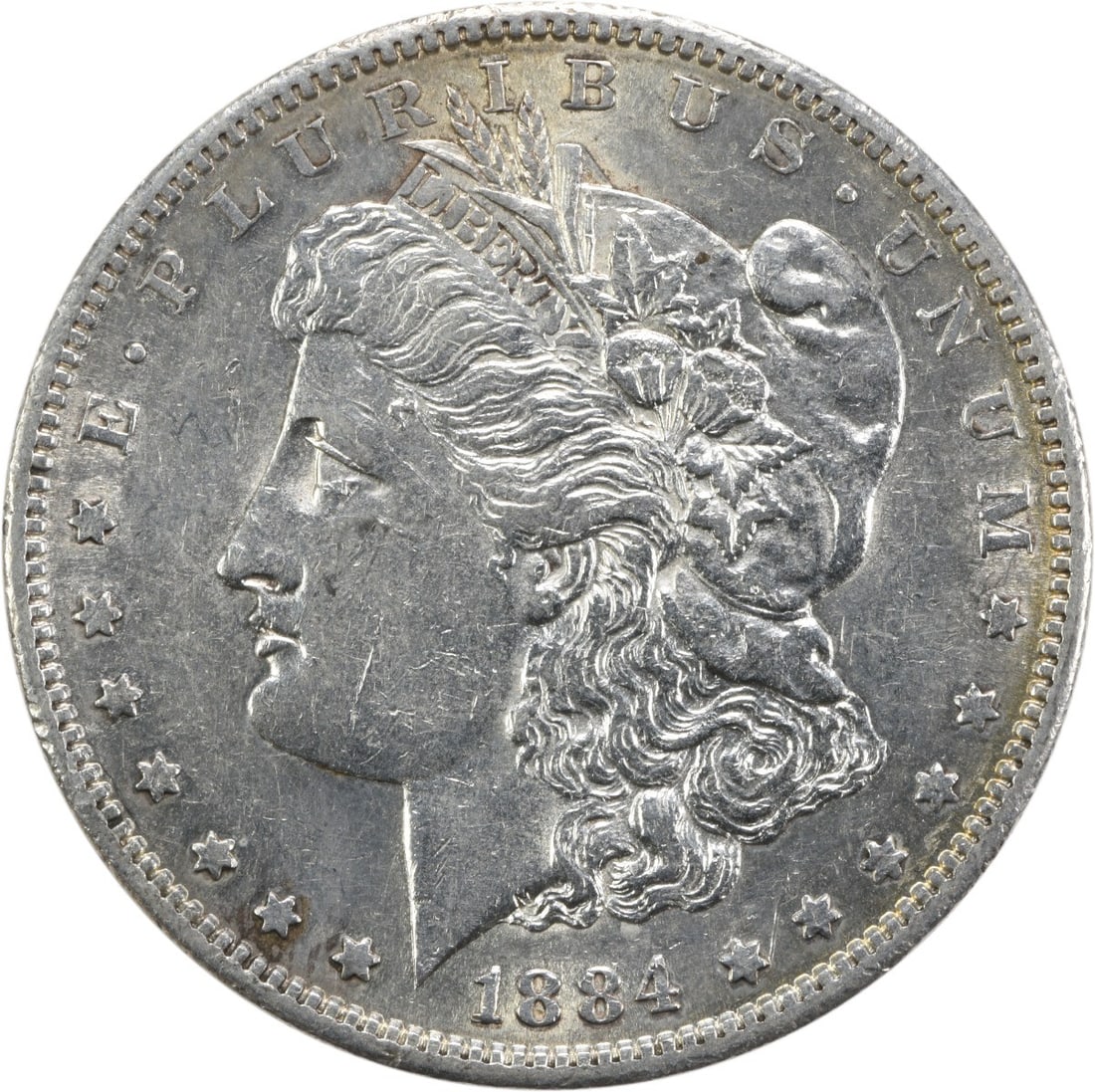 AU Grade 1884 San Francisco Morgan Dollar Uncertified Silver Coin: AU Grade 1884 San Francisco Morgan Dollar Uncertified Silver Coin This 1884-S Morgan Silver Dollar is an attractive collectible coin from the San Francisco Mint. Graded as About Uncirculated (AU) and 