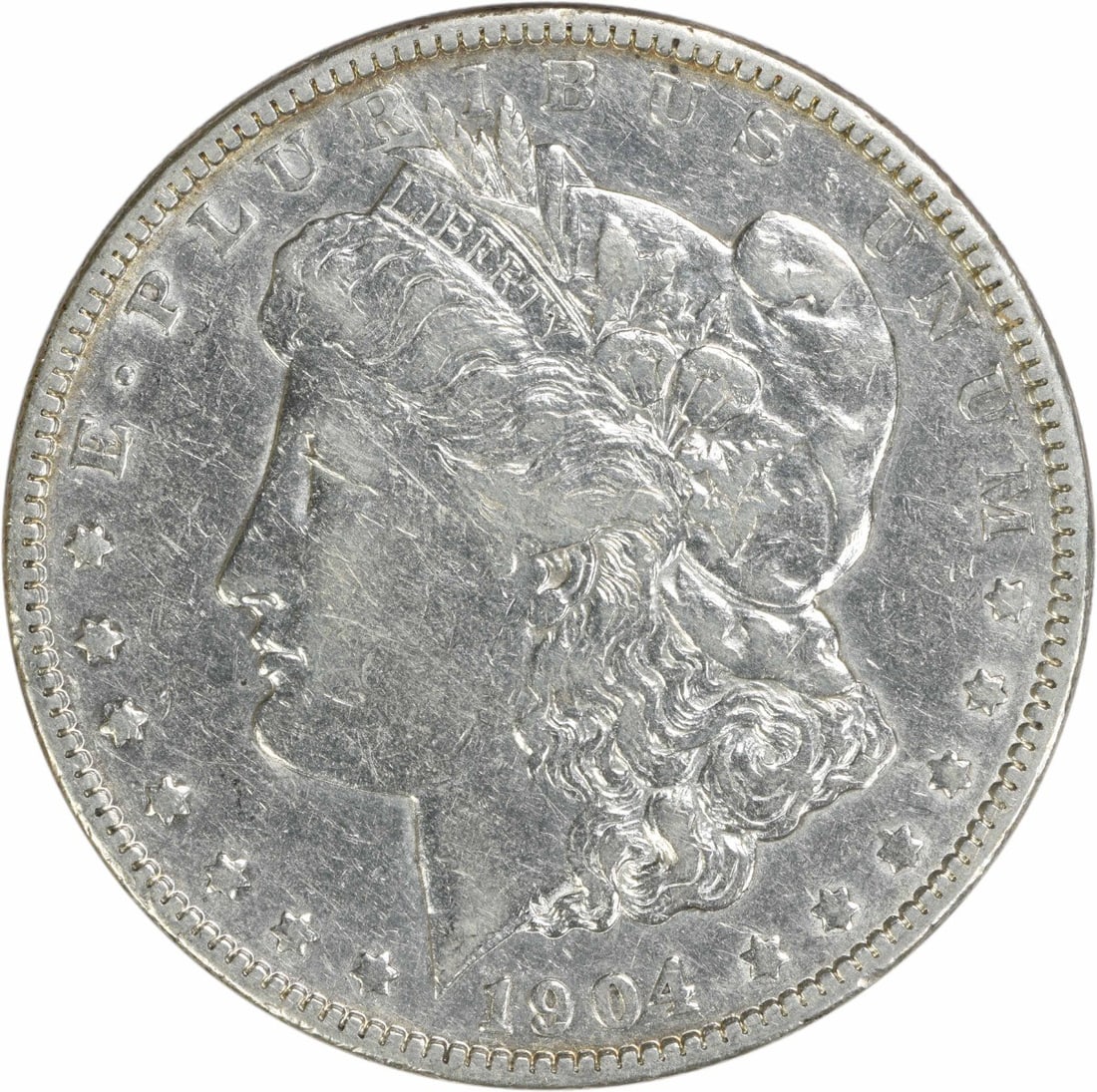 1904 Morgan Silver Dollar EF Uncertified Coin by George T. Morgan: 1904 Morgan Silver Dollar EF Uncertified Coin by George T. Morgan This 1904 Morgan Silver Dollar is a remarkable coin that showcases the elegance of early 20th-century American currency. Struck in Phi