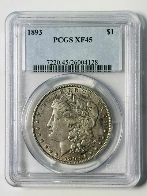 PCGS XF-45 1893 Morgan Silver Dollar Philadelphia: PCGS XF-45 1893 Morgan Silver Dollar Philadelphia An 1893 Morgan Silver Dollar certified by PCGS and graded XF 45. This pre-owned coin is composed of silver, has a denomination of $1, and was minted i