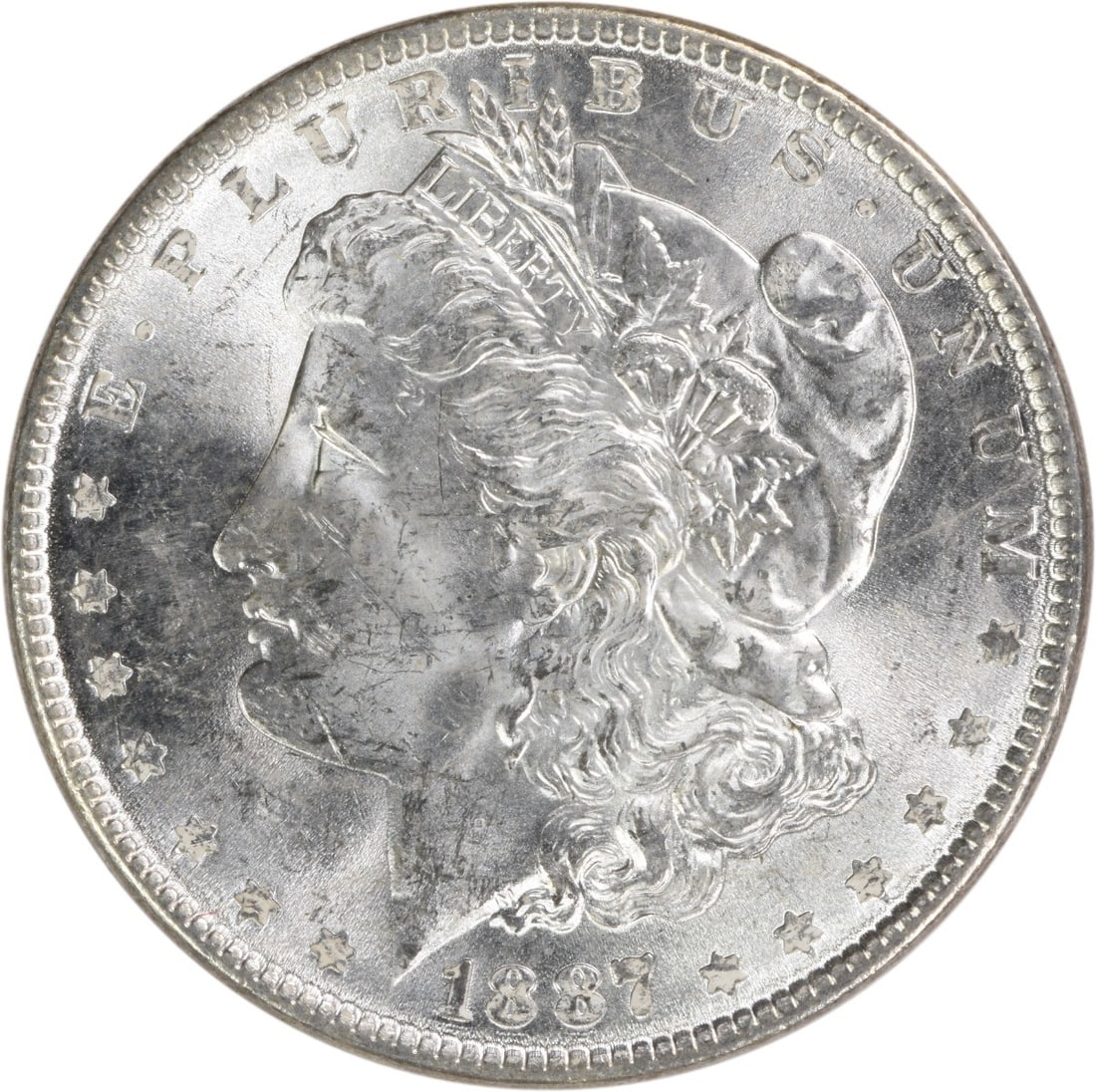 Uncirculated 1887 Silver Dollar Morgan Type Brilliant Uncertified US Coin: Uncirculated 1887 Silver Dollar Morgan Type Brilliant Uncertified US Coin This 1887 Morgan Silver Dollar is an uncirculated, Brilliant Uncirculated (BU) coin from the United States, composed of silver