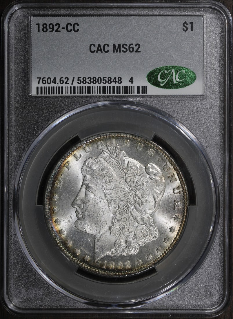 CACG MS62 1892-CC Morgan Silver Dollar $1: CACG MS62 1892-CC Morgan Silver Dollar $1 1892-CC Morgan Silver Dollar graded MS62 by CACG with CAC designation. This pre-owned United States $1 coin is struck in silver and features the Carson City i