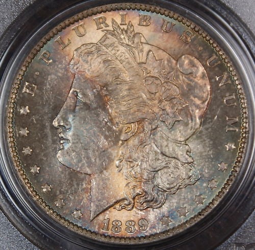 PCGS MS-64 1889 Morgan Silver Dollar Toned: PCGS MS-64 1889 Morgan Silver Dollar Toned 1889 Morgan Silver Dollar coin graded PCGS MS-64 and described as toned. This uncirculated silver $1 coin was minted in the United States and is offered in p