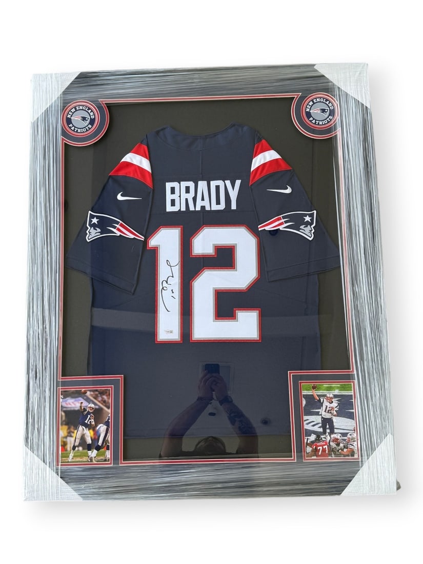 Framed New England Patriots jersey signed by Tom Brady Fanatics Authentic: Framed New England Patriots jersey signed by Tom Brady Fanatics Authentic This custom-framed New England Patriots home jersey features the authentic signature of Tom Brady. The jersey is presented in 