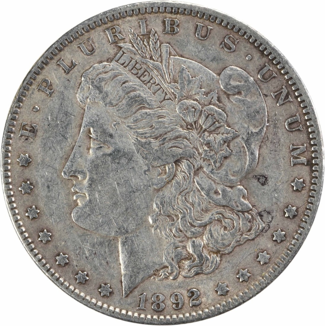 1892 Morgan Silver Dollar Uncertified 90% Silver by George T. Morgan: 1892 Morgan Silver Dollar Uncertified 90% Silver by George T. Morgan This 1892 Morgan Silver Dollar is a stunning piece of history, showcasing the artistry of designer George T. Morgan. This coin, whi