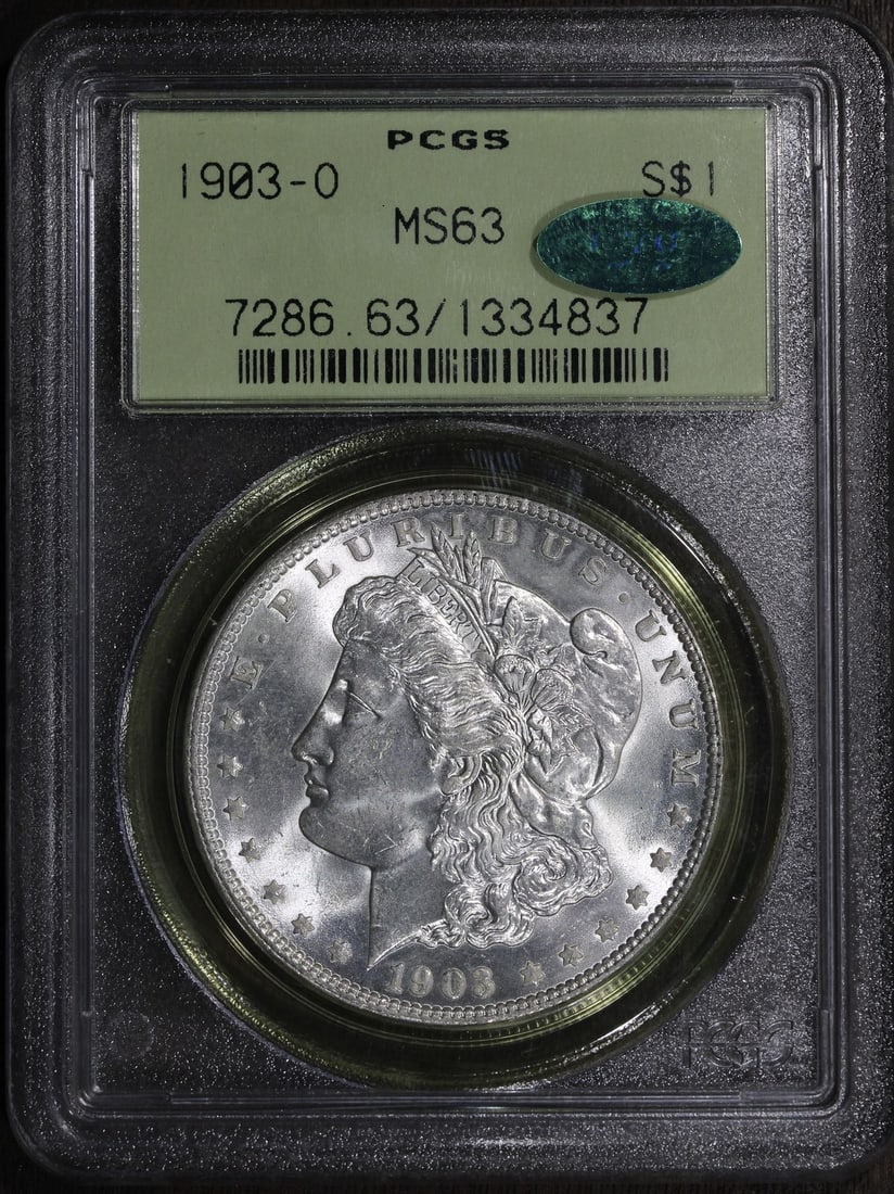 1903 O Morgan Silver Dollar $1 MS63 CAC PCGS Old Green Holder: 1903 O Morgan Silver Dollar $1 MS63 CAC PCGS Old Green Holder 1903-O Morgan Silver Dollar graded MS63 by PCGS and housed in an OGH holder. This pre-owned coin has a CAC designation and is identified i