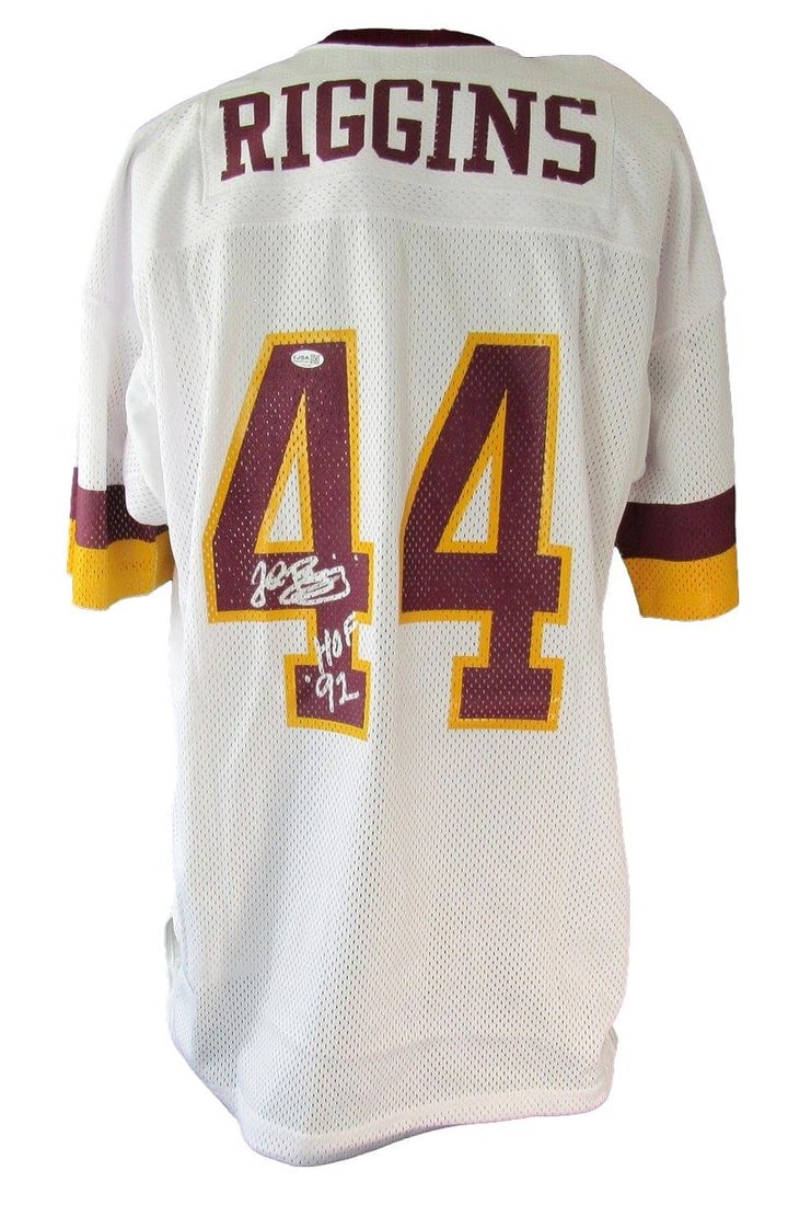 White Mitchell Ness Redskins Throwback Jersey signed by John Riggins JSA: White Mitchell Ness Redskins Throwback Jersey signed by John Riggins JSA Pre-owned white Mitchell & Ness 1982 throwbacks football jersey signed by John Riggins and inscribed "HOF 92." This original je