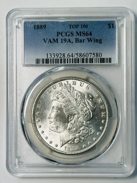 PCGS MS-64 1889 Morgan Silver Dollar VAM 19A Bar Wing: PCGS MS-64 1889 Morgan Silver Dollar VAM 19A Bar Wing 1889 P Morgan Silver Dollar graded MS-64 by PCGS. This pre-owned coin is identified as VAM 19A, Bar Wing, and noted as a White example. Specificat