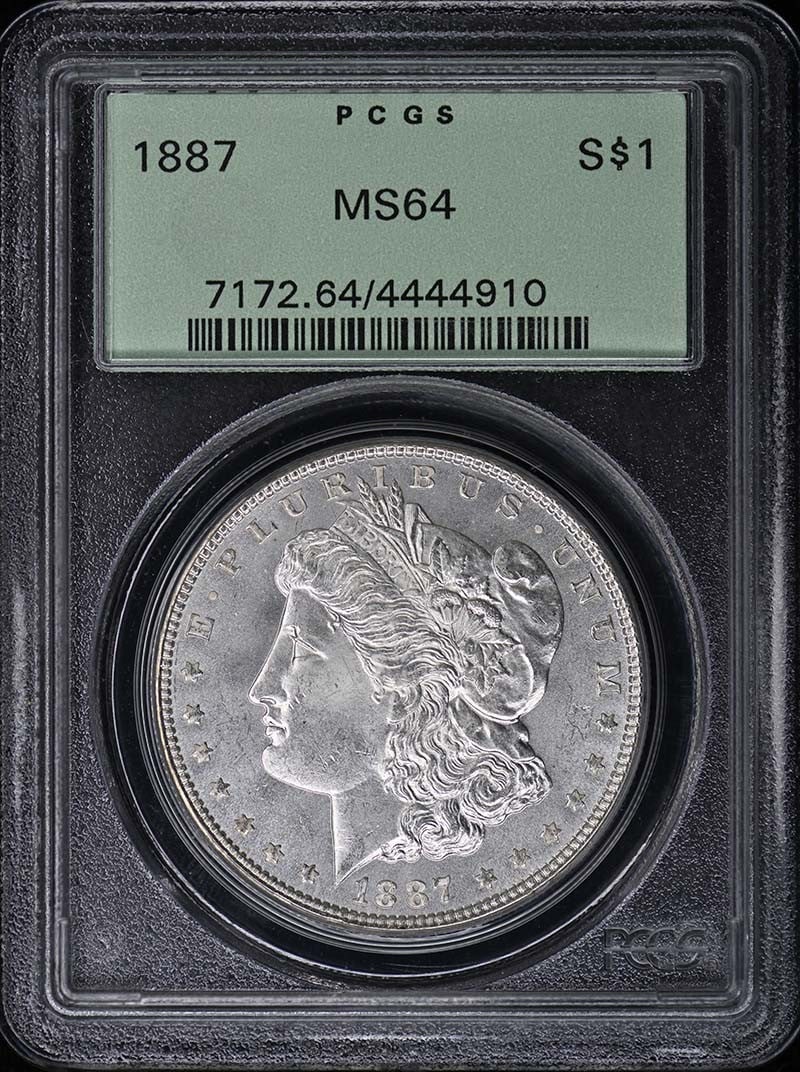 PCGS MS64 1887 Morgan Silver Dollar OGH: PCGS MS64 1887 Morgan Silver Dollar OGH This is an 1887 Morgan Dollar graded MS64 by PCGS and housed in an Old Green Holder (OGH). The coin is uncirculated and originates from the Philadelphia Mint. I