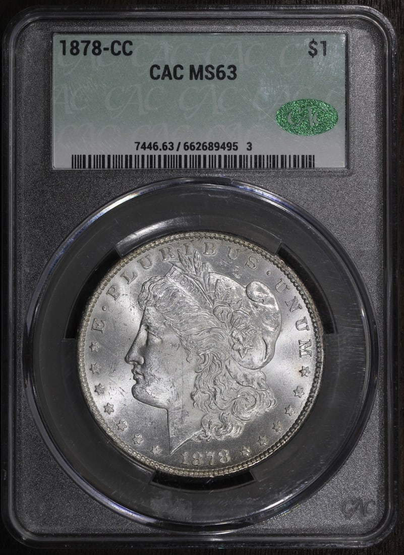 1878 Carson City Morgan Silver Dollar $1 MS63 CACG: 1878 Carson City Morgan Silver Dollar $1 MS63 CACG 1878-CC Morgan Silver Dollar with a CACG MS63 grade. This pre-owned United States coin is composed of .900 fine silver and carries the Carson City de