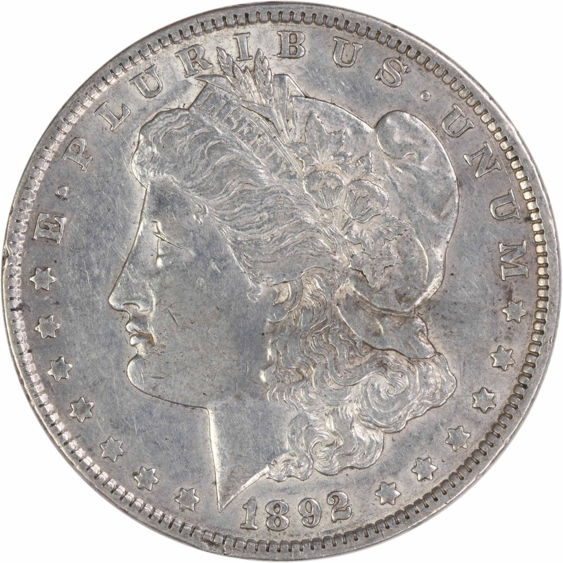 1892 Philadelphia Morgan Dollar 90% Silver Extra Fine Uncertified Coin: 1892 Philadelphia Morgan Dollar 90% Silver Extra Fine Uncertified Coin This is a pre-owned 1892 Morgan Silver Dollar from the Philadelphia Mint, featuring the design by George T. Morgan. Struck in 90%