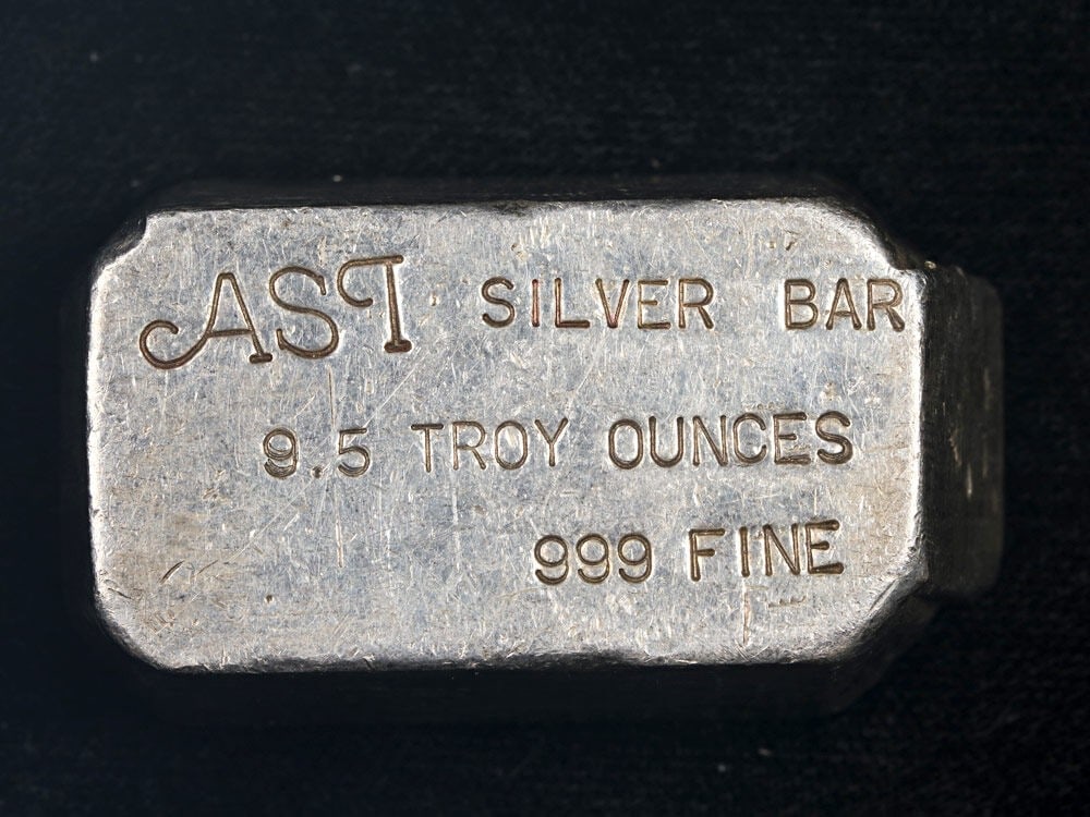 ASI Poured 9.5 Ounce 0.999 Silver Bullion Bar: ASI Poured 9.5 Ounce 0.999 Silver Bullion Bar This vintage 9.5 ounce poured silver bar from Arizona Silver Inc. features a fineness of 99.9% pure silver. The bar has a strong visual appeal with notabl