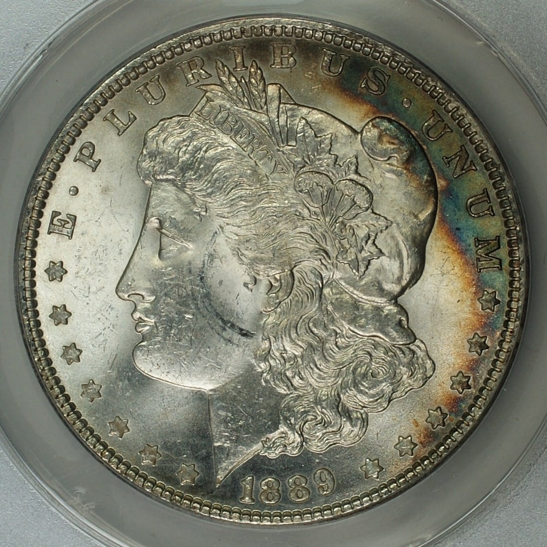 ANACS MS62 1889 Philadelphia Morgan Silver Dollar Toned Uncirculated: ANACS MS62 1889 Philadelphia Morgan Silver Dollar Toned Uncirculated This 1889 Morgan Silver Dollar features a toned finish and has been graded MS-62 by ANACS. Struck at the Philadelphia Mint, this un