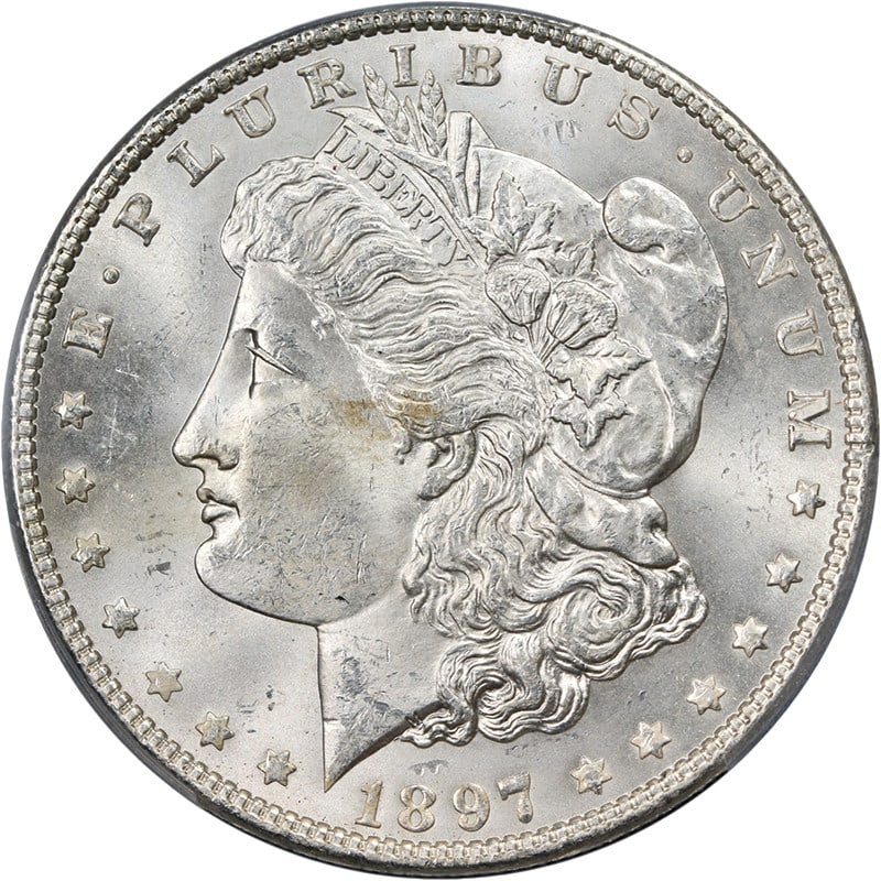 PCGS MS63 1897-P Morgan Dollar Uncirculated Silver Coin: PCGS MS63 1897-P Morgan Dollar Uncirculated Silver Coin This 1897-P Morgan Silver Dollar is graded as MS63 by PCGS, showcasing exceptional eye appeal with a brilliant, blast white finish. The coin fea