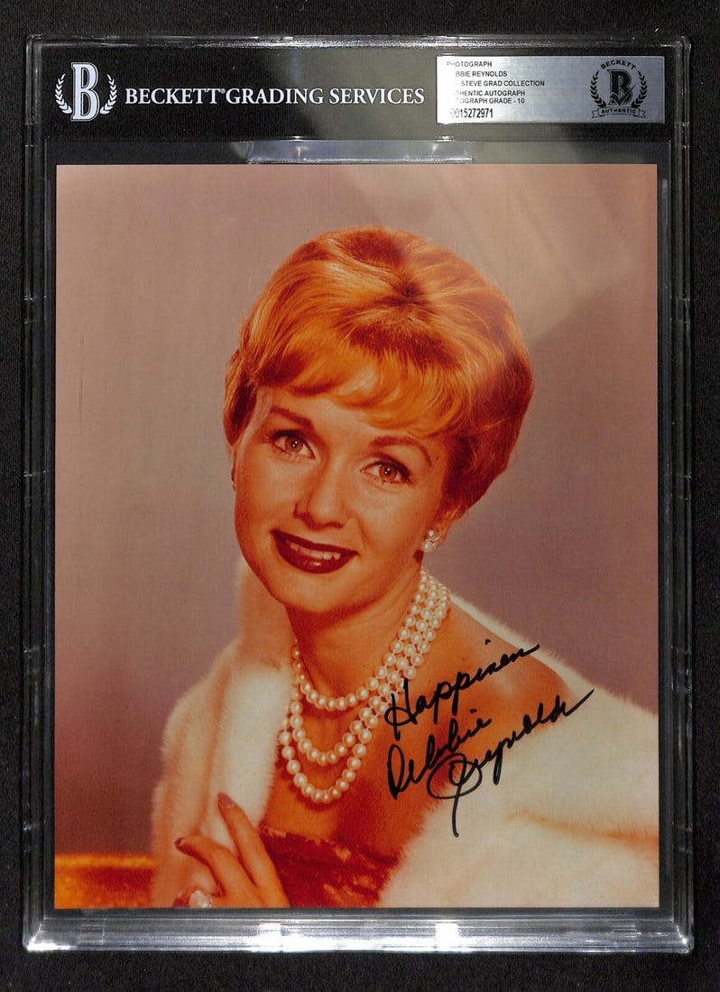 Beckett 10 Graded Debbie Reynolds Autographed 8x10 Photo in Slab: Beckett 10 Graded Debbie Reynolds Autographed 8x10 Photo in Slab This is an original 8x10 color photograph signed by Debbie Reynolds in blue permanent marker. The autograph has been authenticated and 