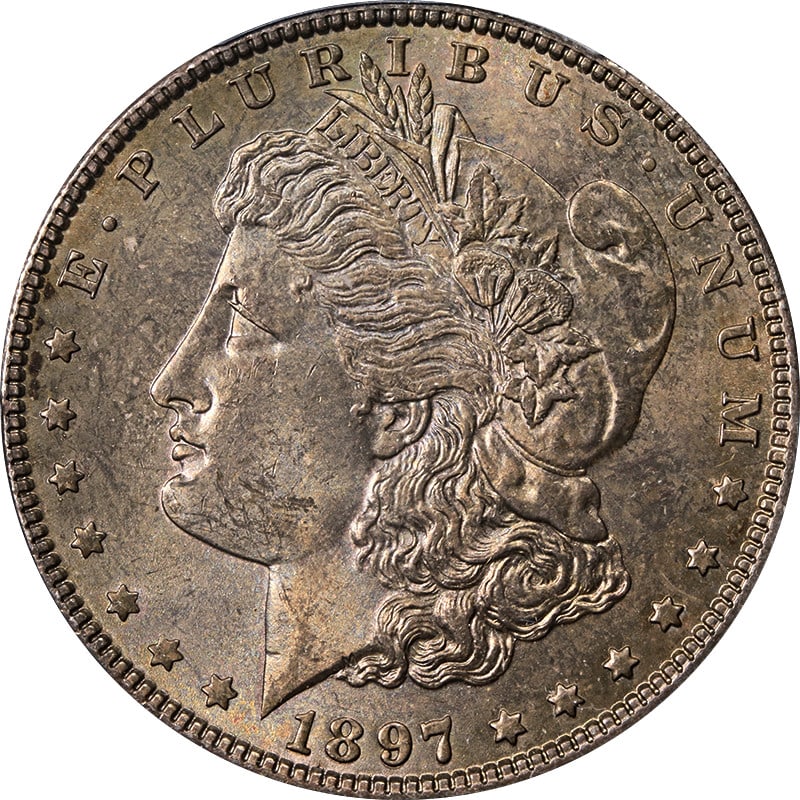 PCGS MS64 1897-P Morgan Dollar Dark Toning: PCGS MS64 1897-P Morgan Dollar Dark Toning This 1897-P Morgan Silver Dollar is graded MS64 by PCGS and features dark toning. Struck in 0.9 fine silver, this uncirculated coin originates from the Phila