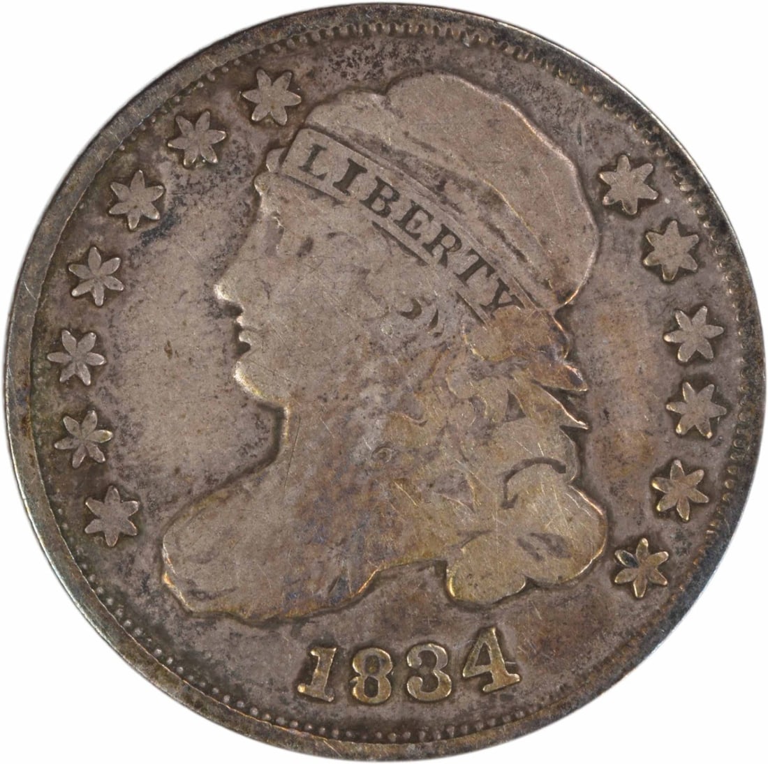 1834 Capped Bust Dime Fine Grade Philadelphia Uncertified Silver Coin: 1834 Capped Bust Dime Fine Grade Philadelphia Uncertified Silver Coin This 1834 Capped Bust silver dime from the Philadelphia Mint is a circulated coin graded as Fine. Designed by John Reich, it featu