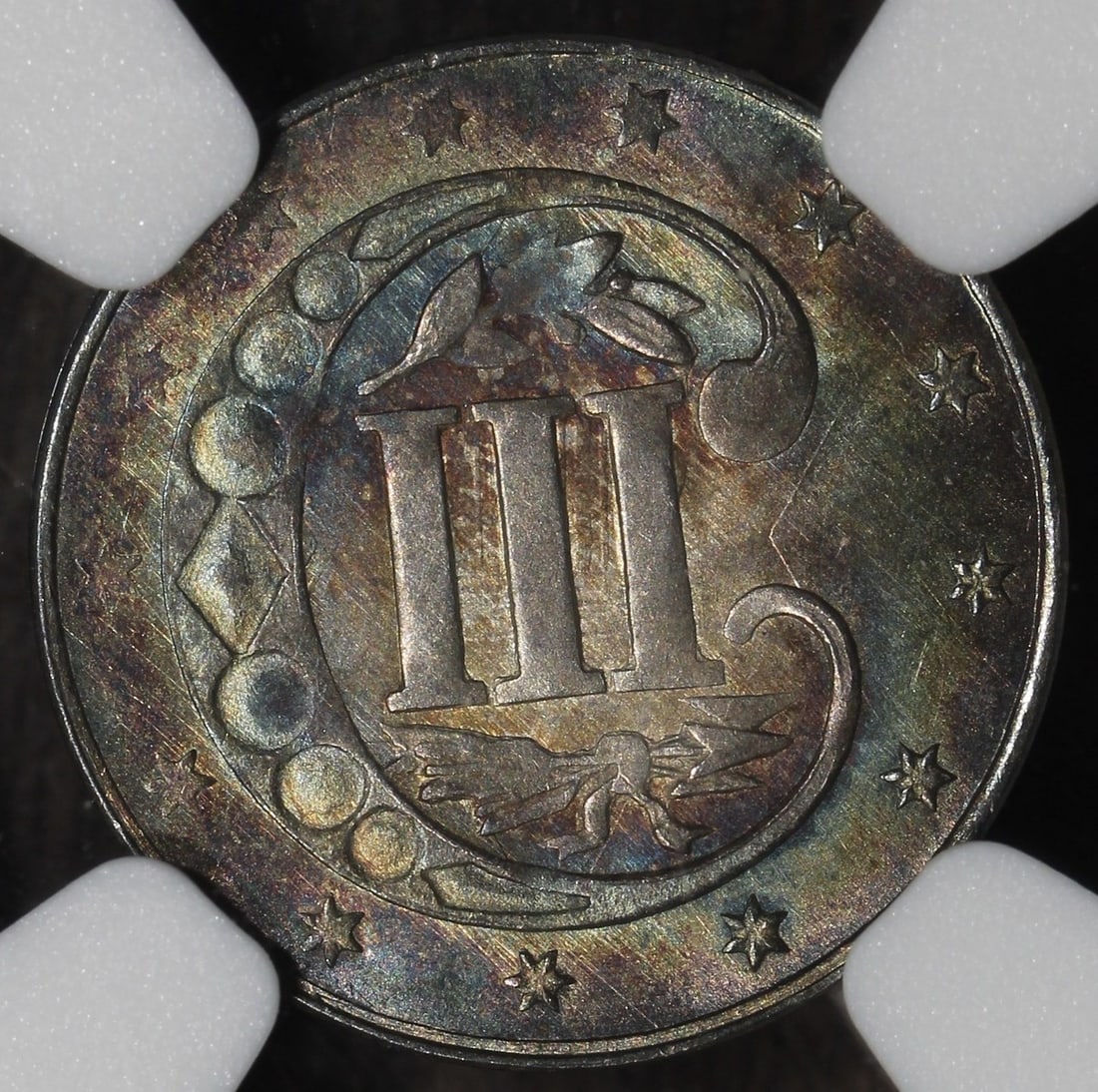 NGC MS64 1861 Silver Trime Colorful Tone: NGC MS64 1861 Silver Trime Colorful Tone This 1861 Three Cent Silver Trime features a colorful tone and has been professionally graded MS64 by the Numismatic Guaranty Company (NGC). Composed of 90% si