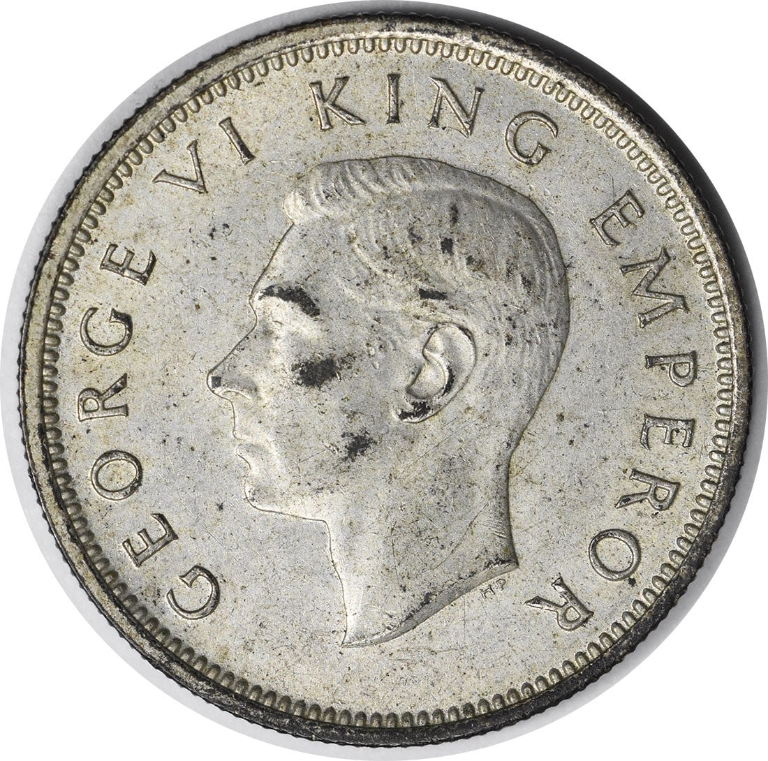 1942 New Zealand One Shilling KM9 About Uncirculated Uncertified Coin: 1942 New Zealand One Shilling KM9 About Uncirculated Uncertified Coin This is a 1942 New Zealand 1 Shilling coin, cataloged as KM9. The coin is circulated and graded as About Uncirculated (AU). It is 