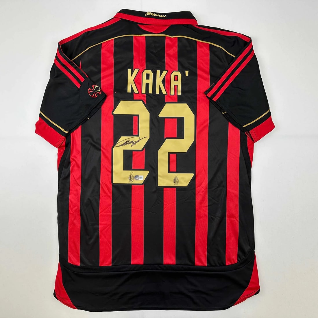 Ricardo Kaka Signed AC Milan Soccer Jersey With Beckett COA: Ricardo Kaka Signed AC Milan Soccer Jersey With Beckett COA This pre-owned AC Milan black and red soccer jersey has been autographed by Ricardo Kaka. The signature has been authenticated by Beckett Gr