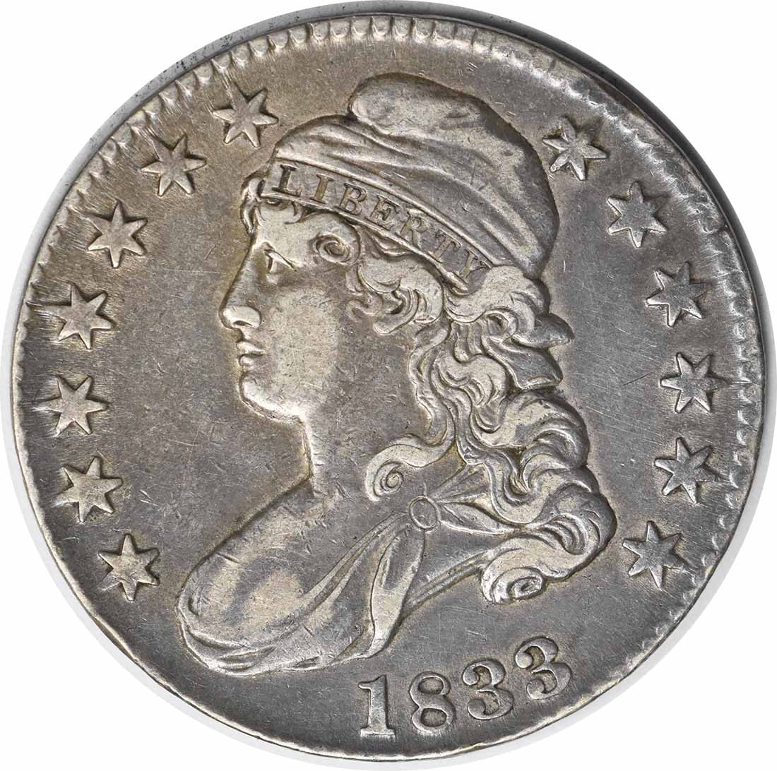 1833 Bust Half Dollar 50C by John Reich Circulated Silver Coin: 1833 Bust Half Dollar 50C by John Reich Circulated Silver Coin This 1833 Bust Half Dollar is a remarkable piece of American numismatic history. Crafted in Philadelphia, this coin features a beautiful 