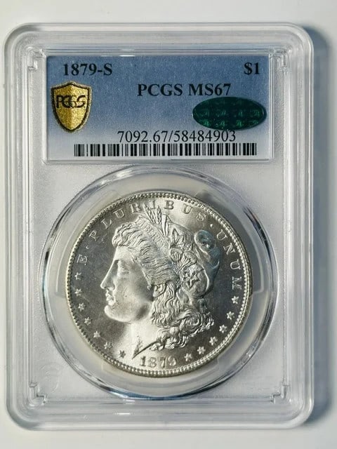PCGS MS-67 CAC 1879-S Morgan Silver Dollar: PCGS MS-67 CAC 1879-S Morgan Silver Dollar 1879-S Morgan Silver Dollar certified by PCGS and CAC. This pre-owned coin is struck in silver and graded MS 67. The title notes a white appearance. Specific