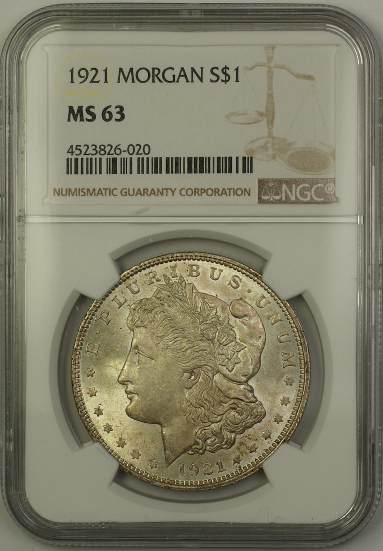 NGC MS 63 1921 Morgan Dollar Silver $1 Light Toning: NGC MS 63 1921 Morgan Dollar Silver $1 Light Toning 1921 Morgan Silver Dollar $1 coin certified by NGC and graded MS-63. This uncirculated United States coin is noted as lightly toned and offered in p