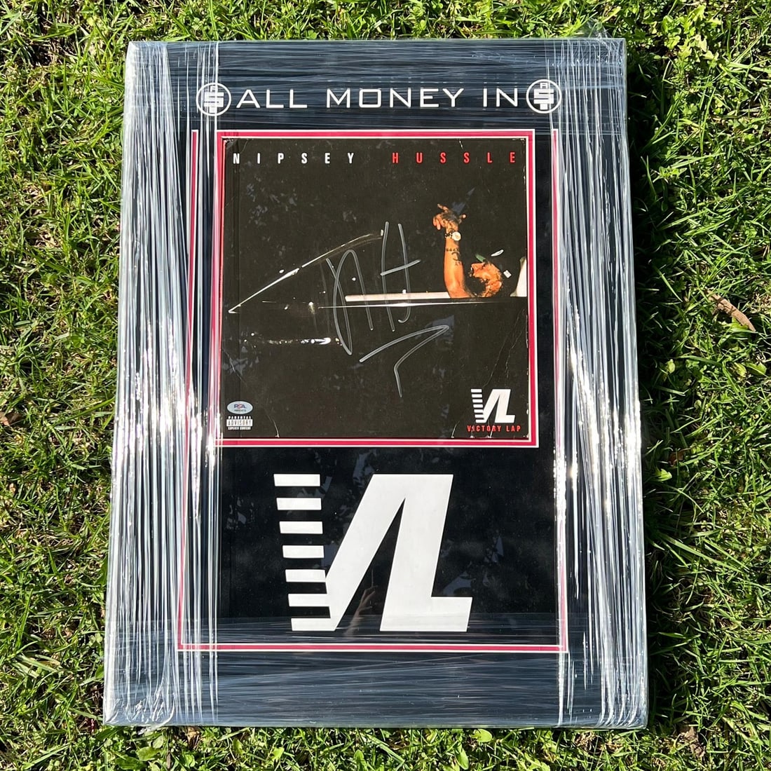 Nipsey Hussle Signed 20x27 Framed Photo with PSA/DNA Authentication: Nipsey Hussle Signed 20x27 Framed Photo with PSA/DNA Authentication This striking 20x27 custom framed and matted photograph features an authentic signature from the late Nipsey Hussle. The autograph h