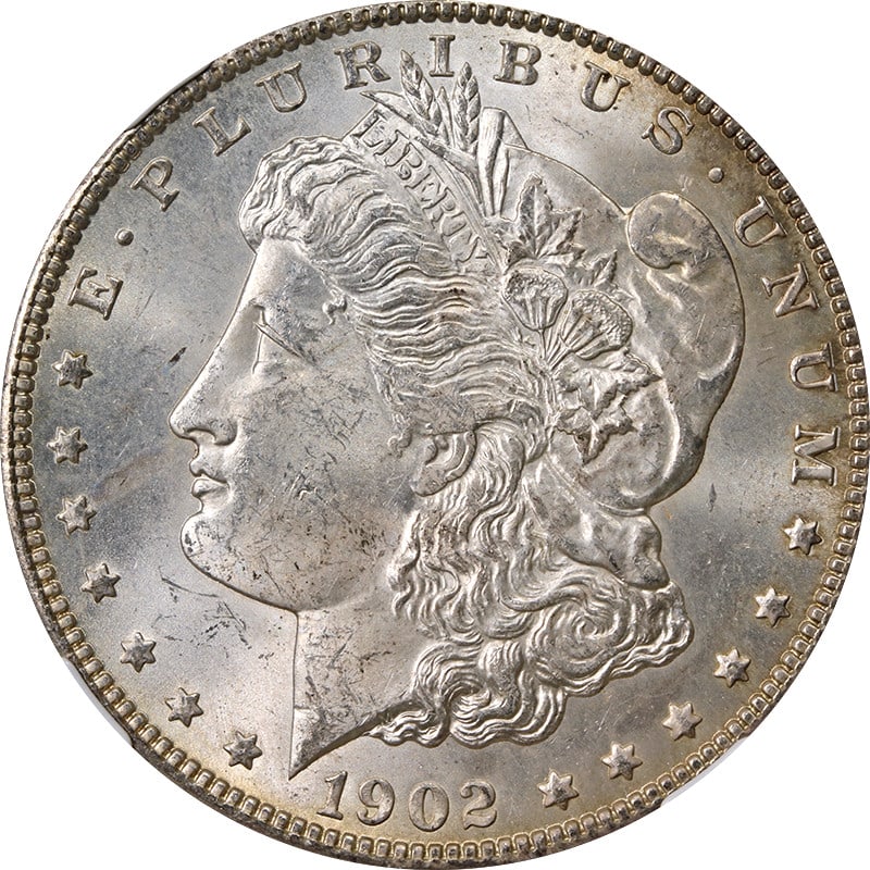 NGC MS63 1902 O Morgan Silver Dollar with Toning: NGC MS63 1902 O Morgan Silver Dollar with Toning 1902-O Morgan Silver Dollar graded NGC MS63 with toning. This pre-owned coin is uncirculated and composed of 90% silver. Specifications Item Type: Morg