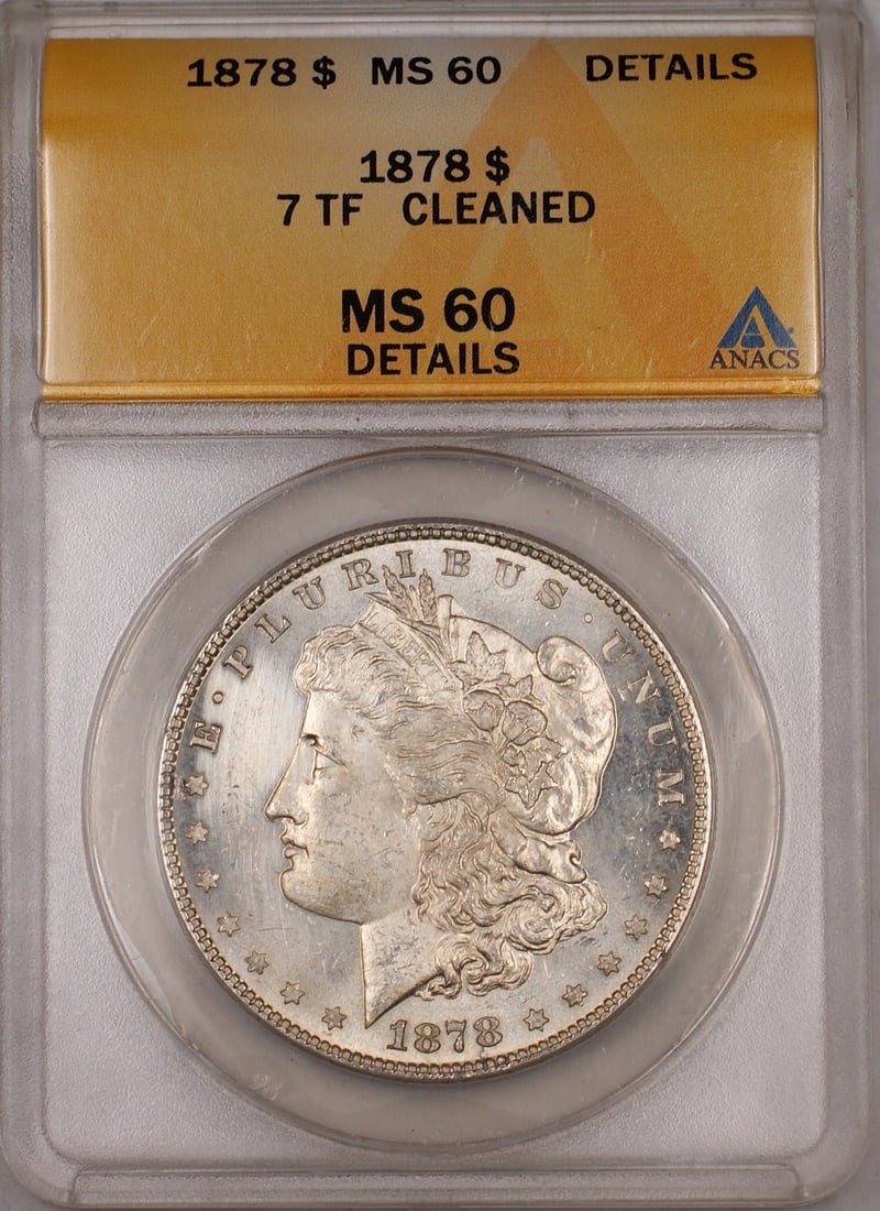 ANACS MS 60 Details 1878 Morgan Silver Dollar 7 TF: ANACS MS 60 Details 1878 Morgan Silver Dollar 7 TF This 1878 7 Tail Feathers Morgan Silver Dollar has been graded MS-60 Details by ANACS and is noted as cleaned. Struck in Philadelphia, this uncircula