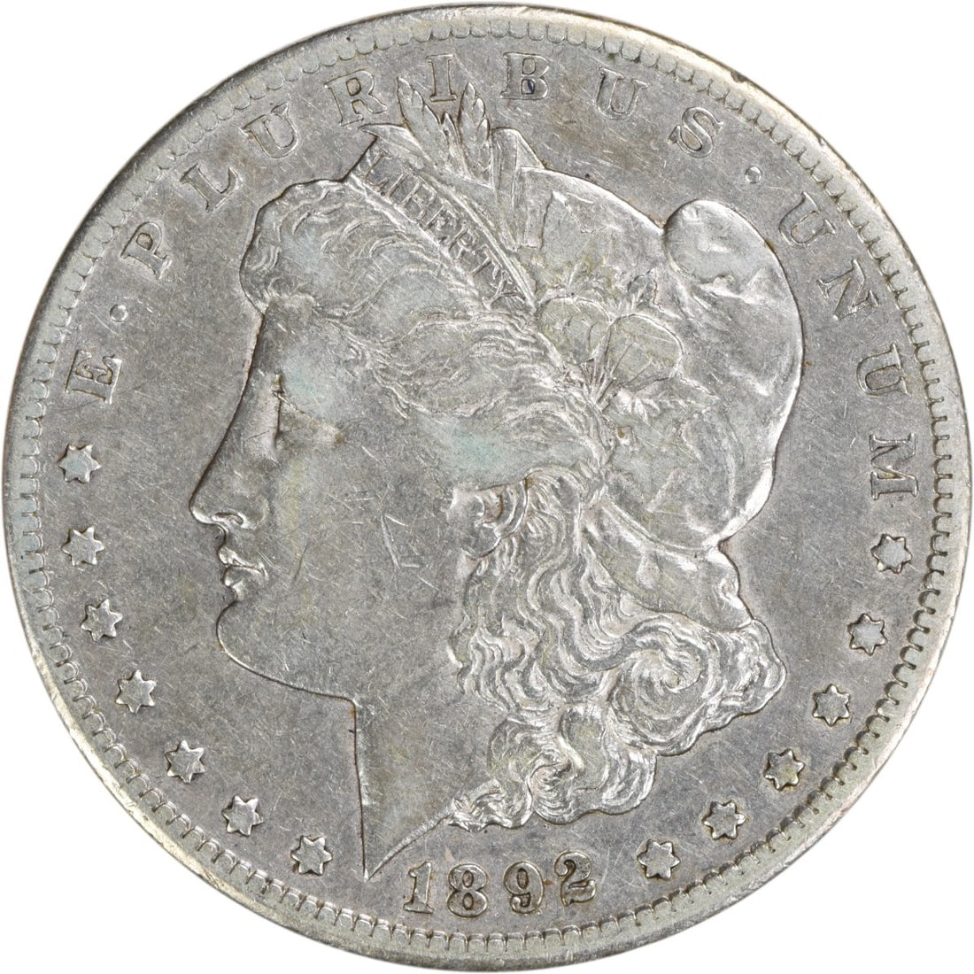 1892-CC Morgan Silver Dollar VF Uncertified 90% Silver Coin: 1892-CC Morgan Silver Dollar VF Uncertified 90% Silver Coin This 1892-CC Morgan Silver Dollar is a remarkable piece of numismatic history featuring the iconic design by George T. Morgan. The coin has 