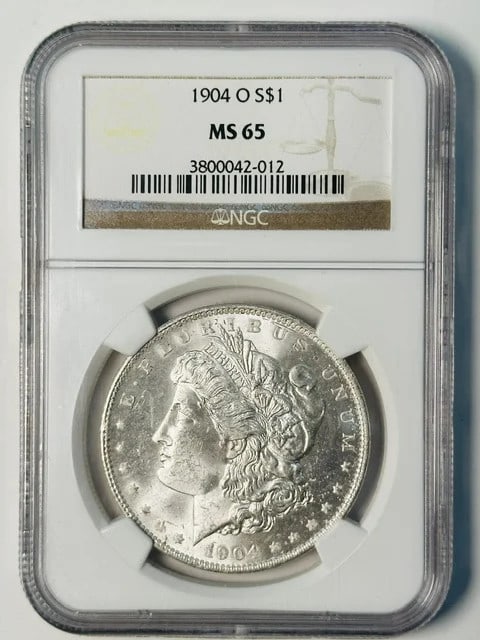 NGC MS-65 1904 O Morgan Silver Dollar: NGC MS-65 1904 O Morgan Silver Dollar 1904 Morgan Silver Dollar certified by NGC and graded MS 65. This silver dollar was minted in New Orleans and is presented in white designation. Pre-owned conditi