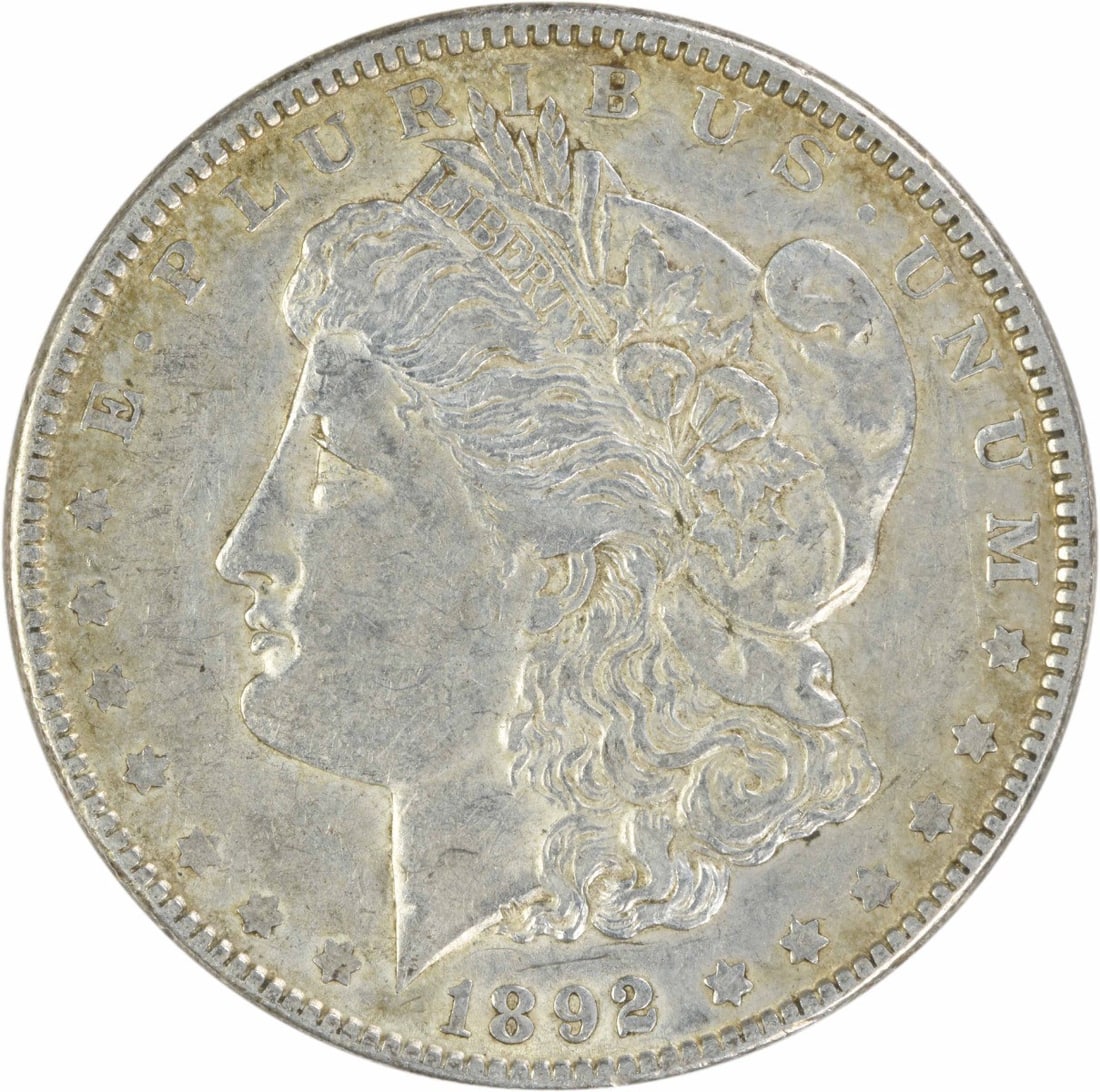 1892 EF Morgan Dollar Uncertified Philadelphia Silver Coin: 1892 EF Morgan Dollar Uncertified Philadelphia Silver Coin 1892 Morgan Silver Dollar in EF grade. This circulated, uncertified coin is composed of 90% silver and 10% copper and features the classic Mo